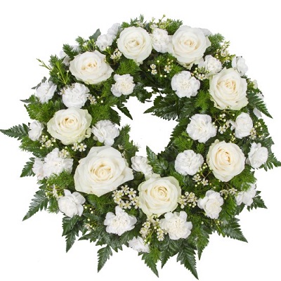 Round funeral wreath with seasonal flowers